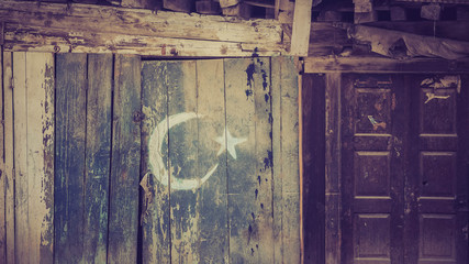 Pakistan flag painted on a wooden wall next to door