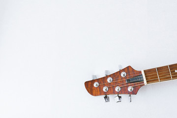 Acoustic guitar detail on white background copy space.