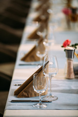 Fototapeta na wymiar Served banquet table wine glasses napkins cutlery