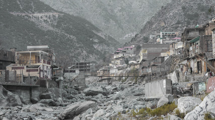 Road of boulders and rows of white houses