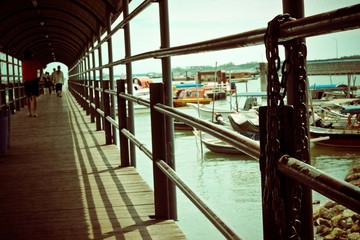 rows of black fence on top of the wooden path