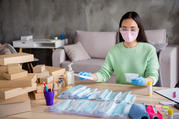 Photo of chinese lady hands latex gloves business organize order face medical masks handmade package sorting carton boxes online delivery shop commerce manager home office indoors