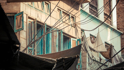 Rows of opened green wooden windows with wires