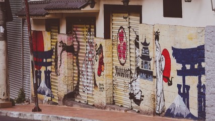 Rows of walls with graffiti and tall pole
