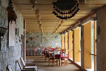 Rows of wooden chairs with table next to window