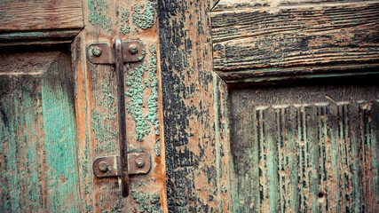 Rusty metal handlebar on the green door