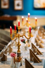 Served banquet table with candelabrum wine glasses