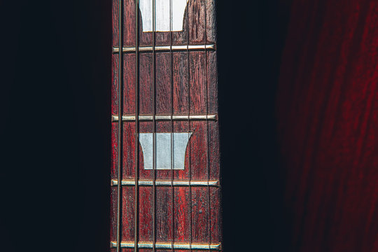 mahogany guitar neck and six strings 