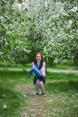 Fototapeta premium Yay, vacation! Happy girl in school uniform with school bag. The concept of pre-school education.