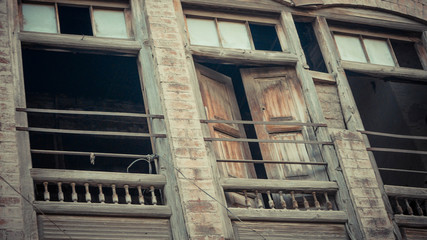 Tilted picture of opened window with railings on