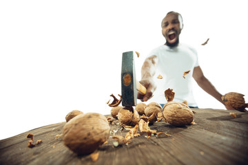 Amazing african-american man preparing unbelievable food with action, details and bright emotions,...