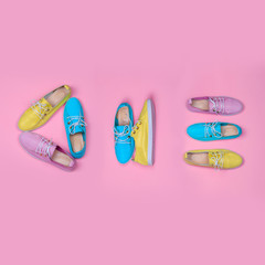 Female shoes. Top view flat lay design concept. Woman footwear on pink background.