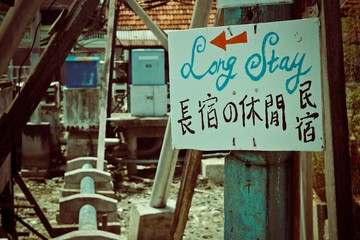 White sign on top of the blue pillar