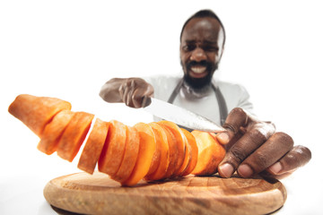 Amazing african-american man preparing unbelievable food with action, details and bright emotions,...