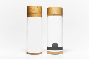 Close-up of two cylinder cardboard boxes with empty sticker for mockup isolated on white studio background.