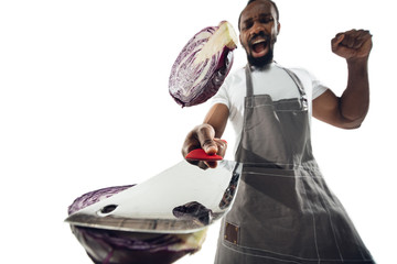 Amazing african-american man preparing unbelievable food with action, details and bright emotions,...