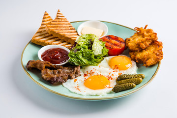 Breakfast set fried egg bacon potato pancake toast