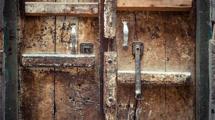 Wooden door with metal handlebar with scartches