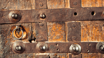 Wooden door with rings mounted on the surface