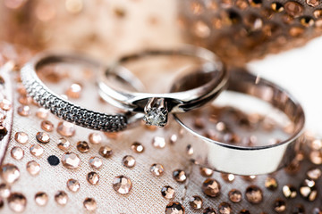wedding rings, gold rings with precious stones for the bride and groom close-up on the background...