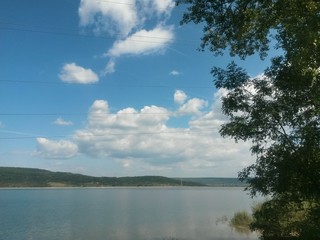 lake reflecting sunset with colored clouds in the forest