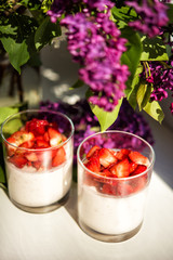 Vertical close-up picture of layered strawberry homemade italian creamy dessert panna cotta with...