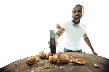 Amazing african-american man preparing unbelievable food with action, details and bright emotions,...