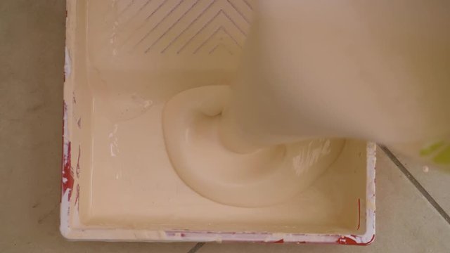  pouring the light pink tempera into the paint tray - slow motion