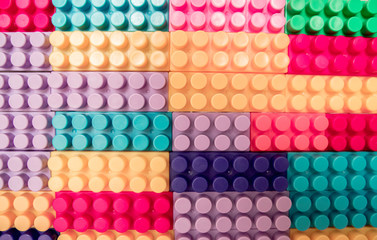 Designer items built like a wall. Color children's designer as background and texture.