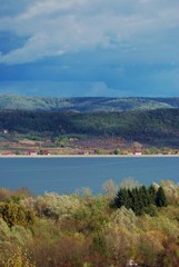 lake in fall season reflecting colorfully forest on the day