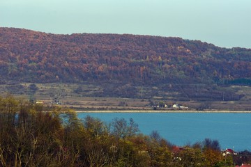 lake in fall season reflecting colorfully forest on the day