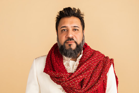 Indian man wearing a kurta with a red scarf