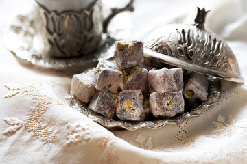 Turkish delight with coffee and traditional silver serving set. Feast of Ramadan.