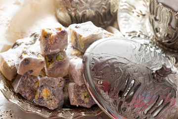 Turkish delight with coffee and traditional silver serving set. Feast of Ramadan.