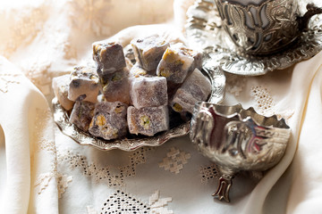 Turkish delight with coffee and traditional silver serving set. Feast of Ramadan.
