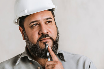 Thoughtful senior male Indian engineer