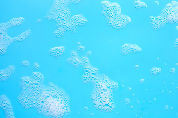 Fototapeta na wymiar Foam on blue background. Top view