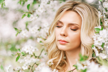 Fototapeta premium portrait of a woman in a blooming garden.