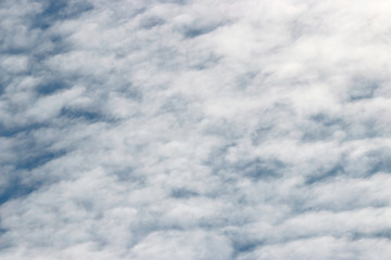 Light altocumulus clouds on blue sky closeup