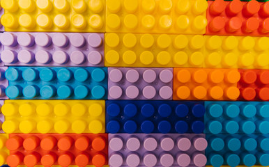 Designer items built like a wall. Color children's designer as background and texture.