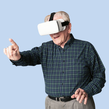 Cheerful senior man wearing virtual reality goggles mockup