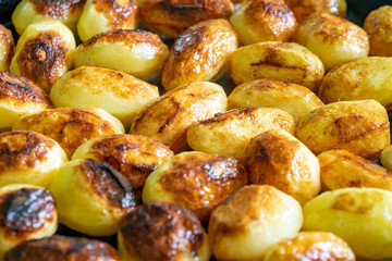 Small fresh potatoes fried in olive oil on frying pan