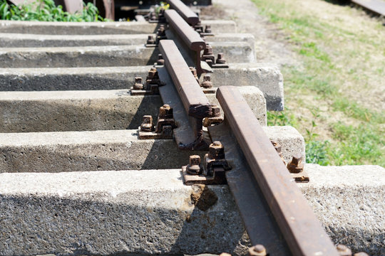 Hardened steel railroad tracks photographed on a sunny spring day