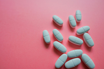 White pills  on a colorful background with a free area for text