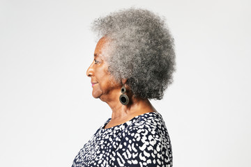 Black senior woman with afro hair in a profile shot - Powered by Adobe