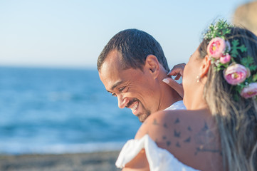 close up of a happy groom with the affection of his bride. Focus on the groom. Great copy space.