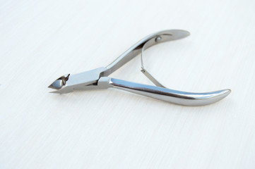 Cuticle clippers on a white background. Metal instruments for manicure and pedicure
