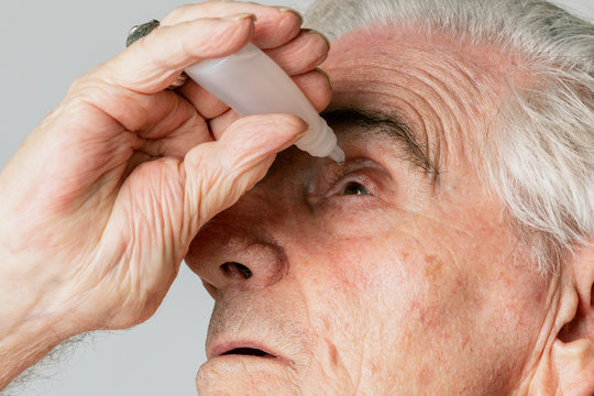 Closeup Senior Man Applying Eye Drops