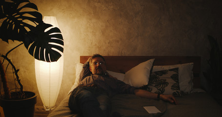 Man switching lighting on and off with home hub