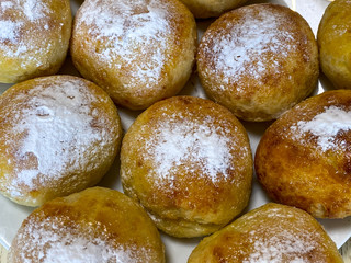 Homemade buns sprinkled with powdered sugar